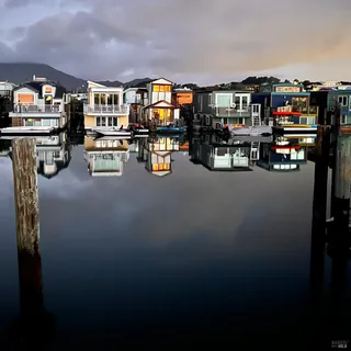 a view of a house with wooden deck and furniture