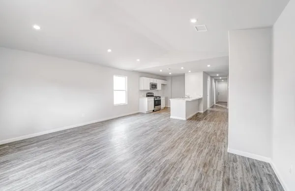 a view of a kitchen with wooden floor and kitchen