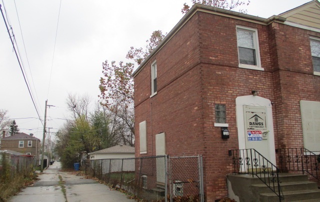415 West 99th Place Chicago, IL 60628 - Photo 13 of 14 a front view of a house with iron fence