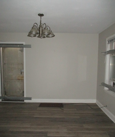 415 West 99th Place Chicago, IL 60628 - Photo 4 of 14 a view of a room with wooden floor and ceiling fan