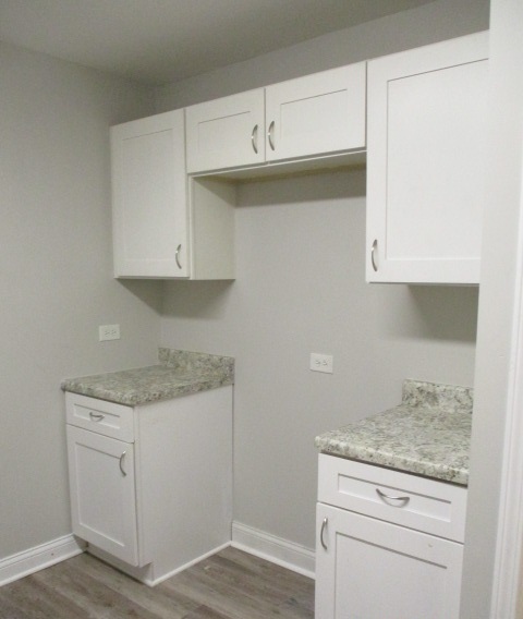 415 West 99th Place Chicago, IL 60628 - Photo 5 of 14 a kitchen with granite countertop white cabinets and a stove