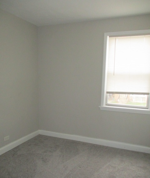 415 West 99th Place Chicago, IL 60628 - Photo 9 of 14 an empty room with a window