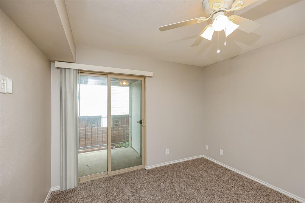 4622 Monarch Street, Unit 202 Dallas, TX 75204 - Photo 12 of 16 Carpeted interior space featuring a sliding glass door to an exterior balcony