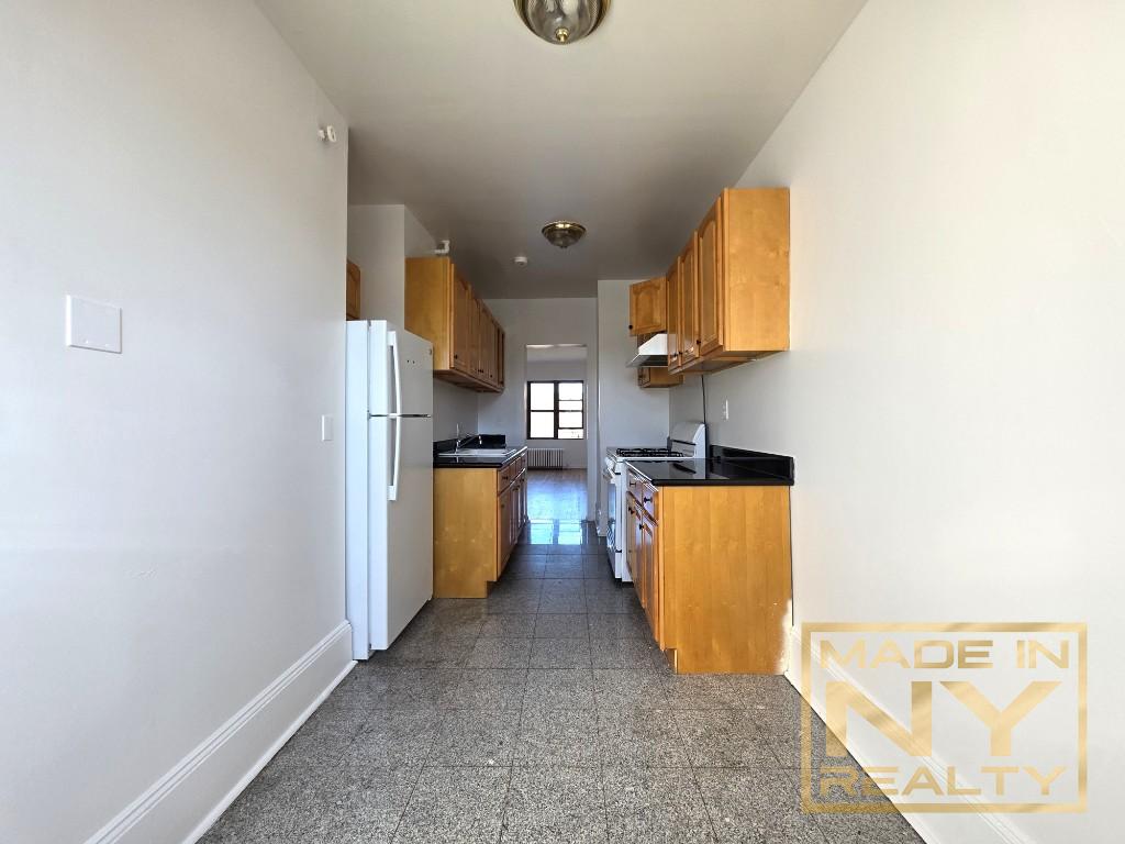 117-14 Union Turnpike, Unit BF1 Queens, NY 11415 - Photo 2 of 9 a view of kitchen with windows