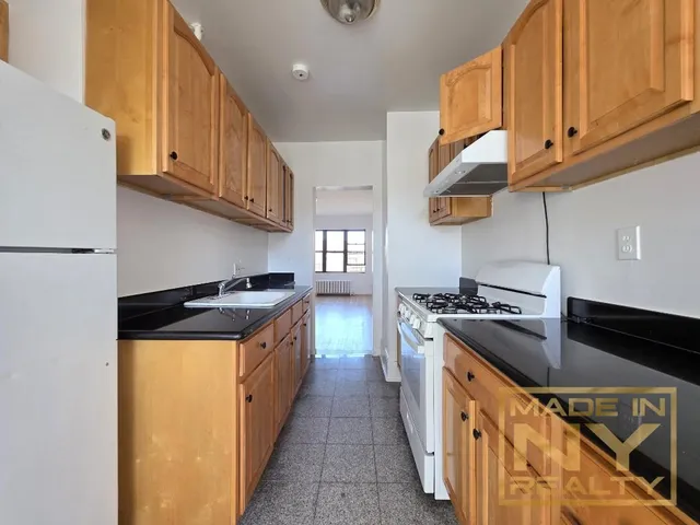 a kitchen with stainless steel appliances granite countertop a stove and a refrigerator