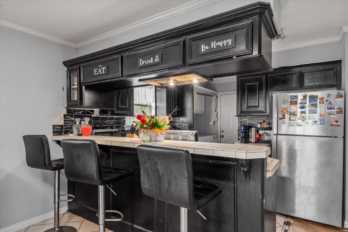 23011 Bayleaf Drive Spring, TX 77373 - Photo 10 of 22 a kitchen with stainless steel appliances a table and chairs in it