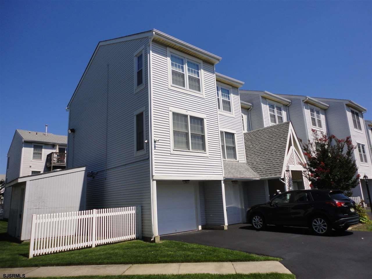 167 40th Street South, Unit 2 Brigantine, NJ 08203 - Photo 1 of 28 a front view of a house with a garden