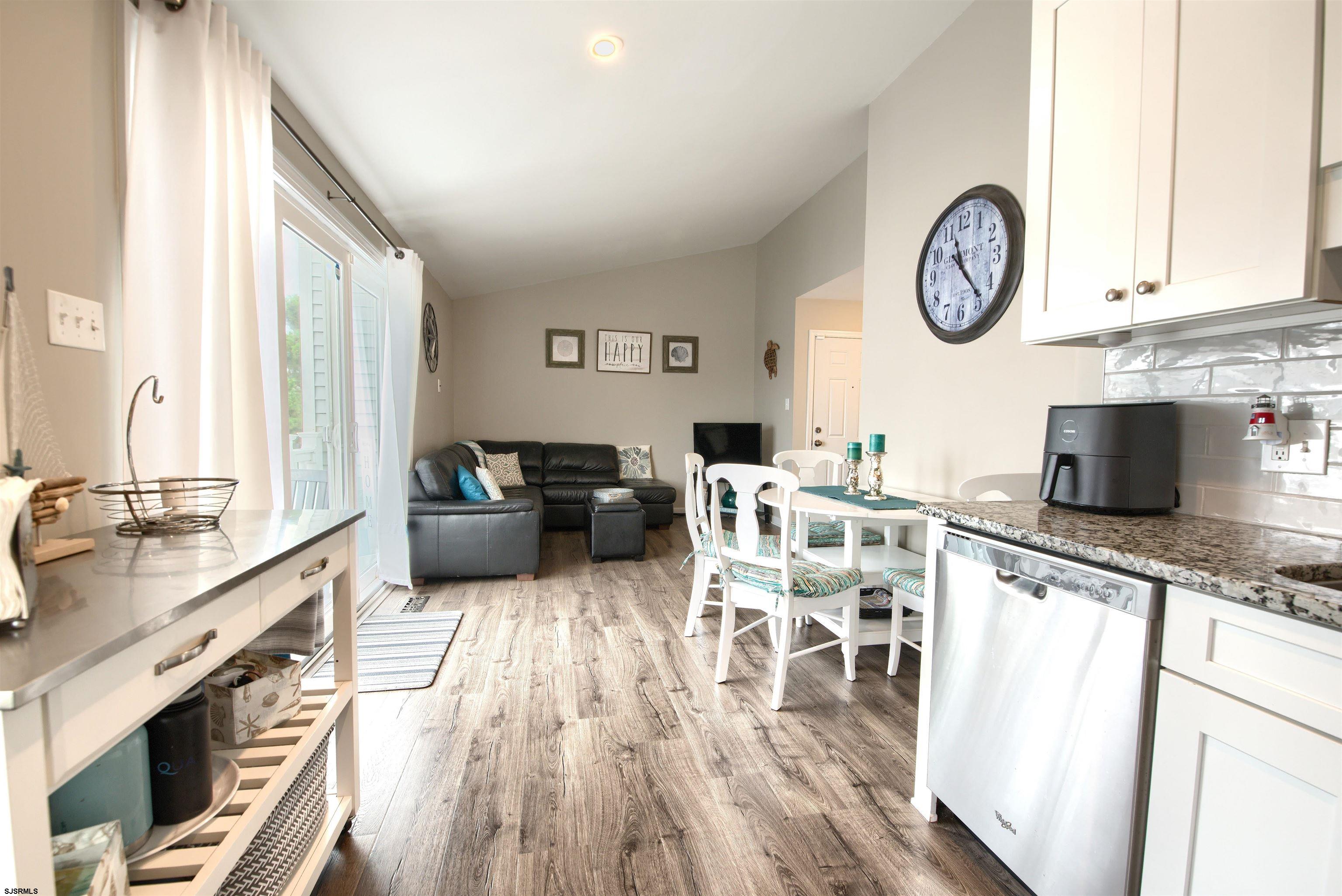 167 40th Street South, Unit 2 Brigantine, NJ 08203 - Photo 11 of 28 a living room with stainless steel appliances granite countertop furniture a fireplace and a flat screen tv