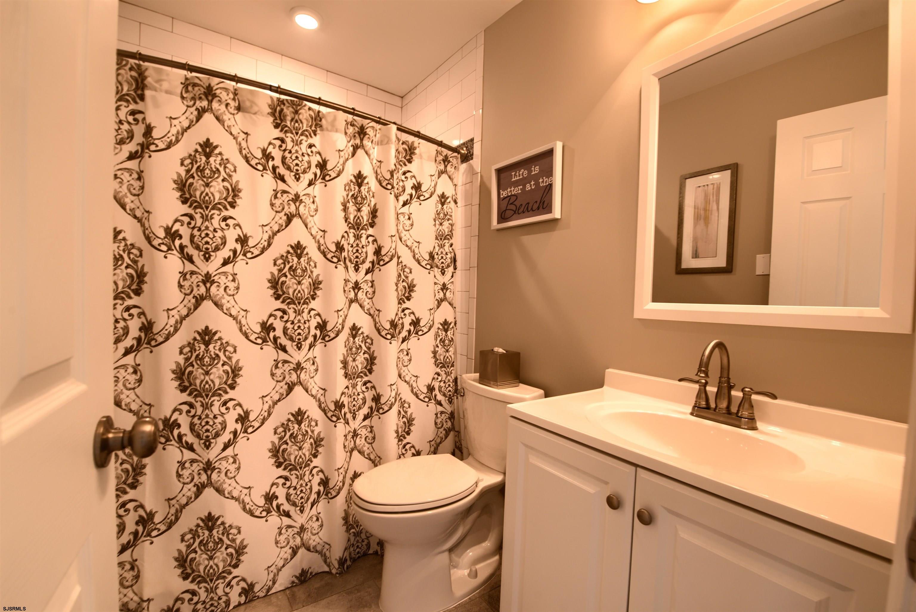 167 40th Street South, Unit 2 Brigantine, NJ 08203 - Photo 16 of 28 a bathroom with a sink toilet and shower