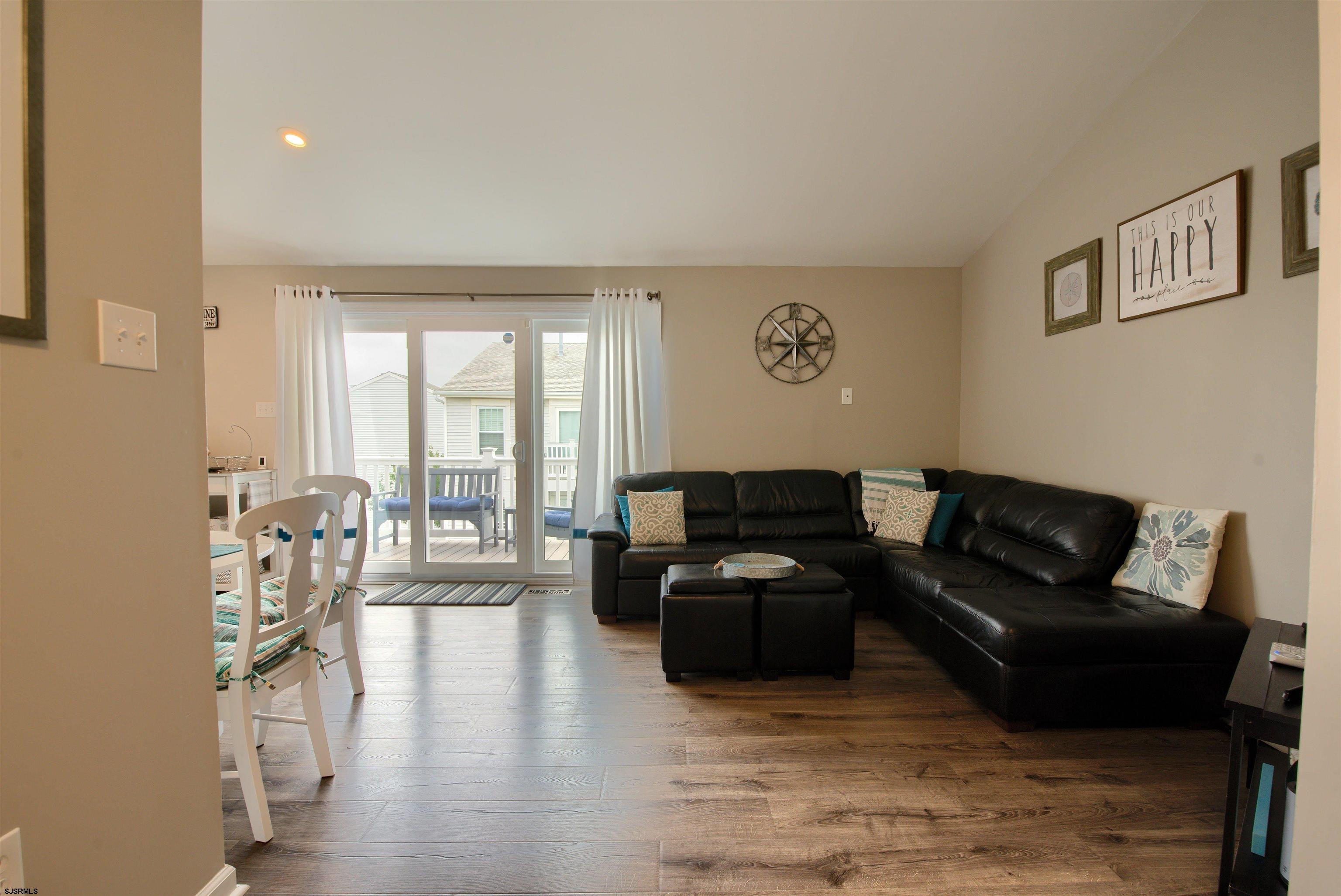 167 40th Street South, Unit 2 Brigantine, NJ 08203 - Photo 8 of 28 a living room with furniture wooden floor and a large window