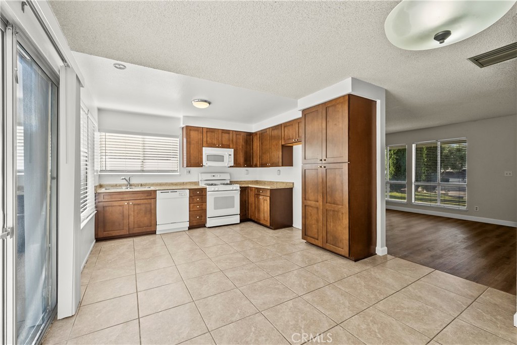 30008 Abelia Road Canyon Country, CA 91387 - Photo 13 of 32 a kitchen with stainless steel appliances a refrigerator sink and cabinets