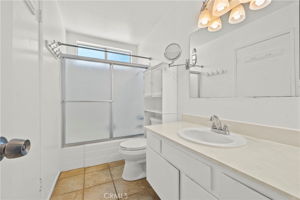 30008 Abelia Road Canyon Country, CA 91387 - Photo 14 of 32 a bathroom with a sink a toilet and shower