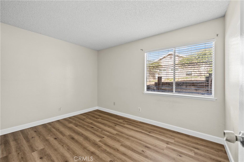 30008 Abelia Road Canyon Country, CA 91387 - Photo 18 of 32 a view of a room with wooden floor and windows