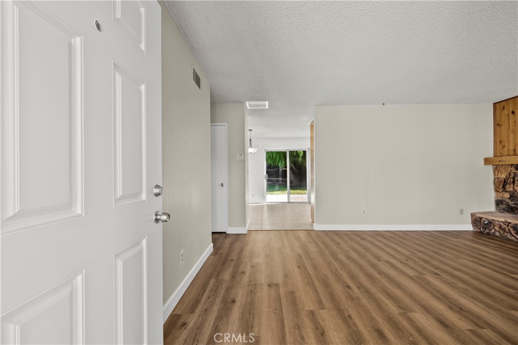 30008 Abelia Road Canyon Country, CA 91387 - Photo 2 of 32 a view of a room with wooden floor and a bathroom