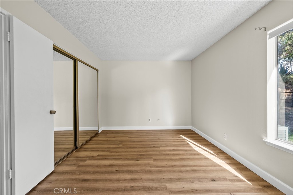 30008 Abelia Road Canyon Country, CA 91387 - Photo 23 of 32 a view of a room with wooden floor and a window
