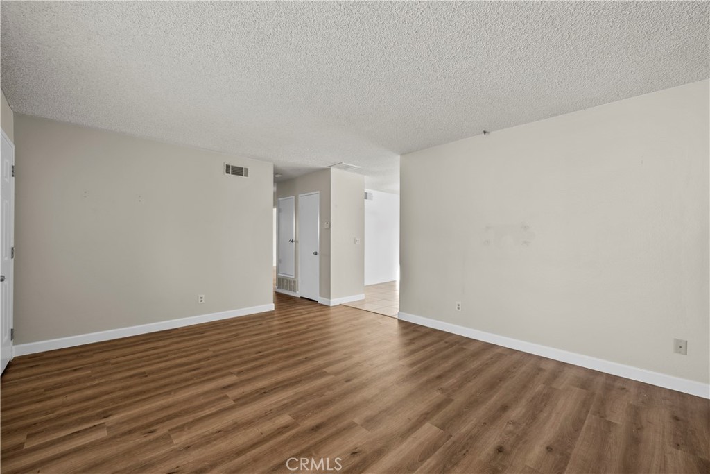 30008 Abelia Road Canyon Country, CA 91387 - Photo 3 of 32 a view of an empty room with wooden floor