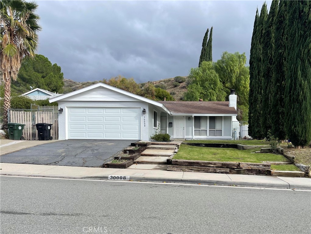 30008 Abelia Road Canyon Country, CA 91387 - Photo 31 of 32 a front view of a house with a yard