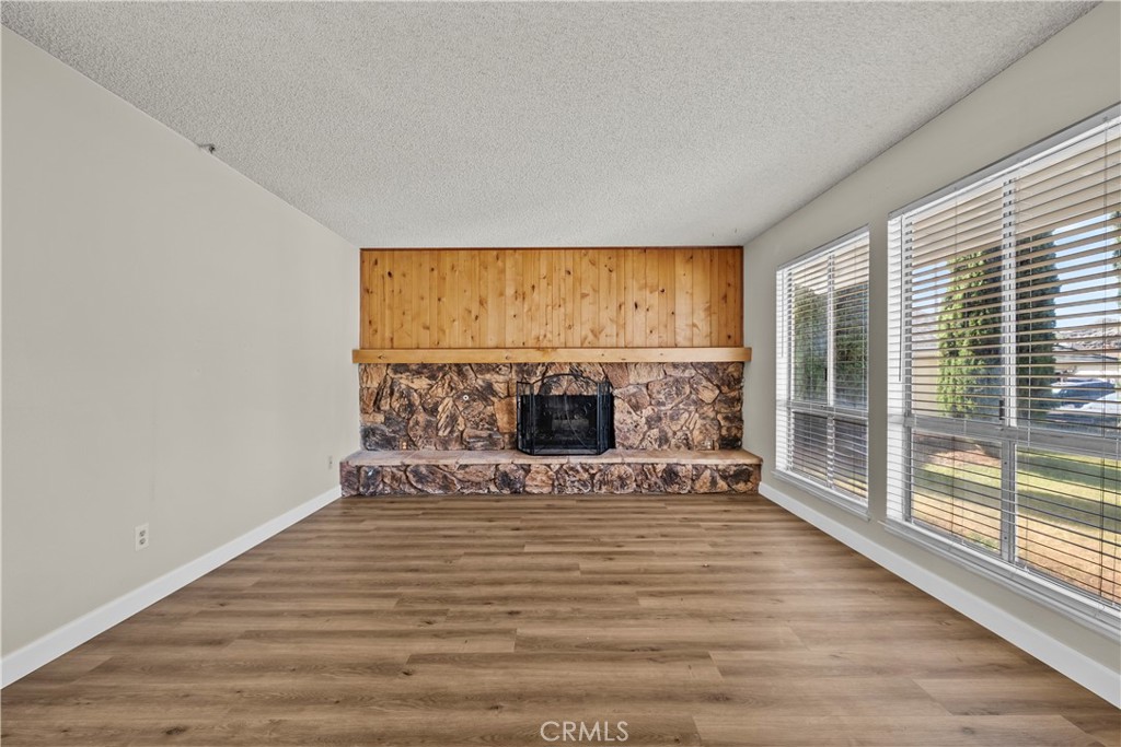 30008 Abelia Road Canyon Country, CA 91387 - Photo 4 of 32 a view of a livingroom with wooden floor and a fireplace