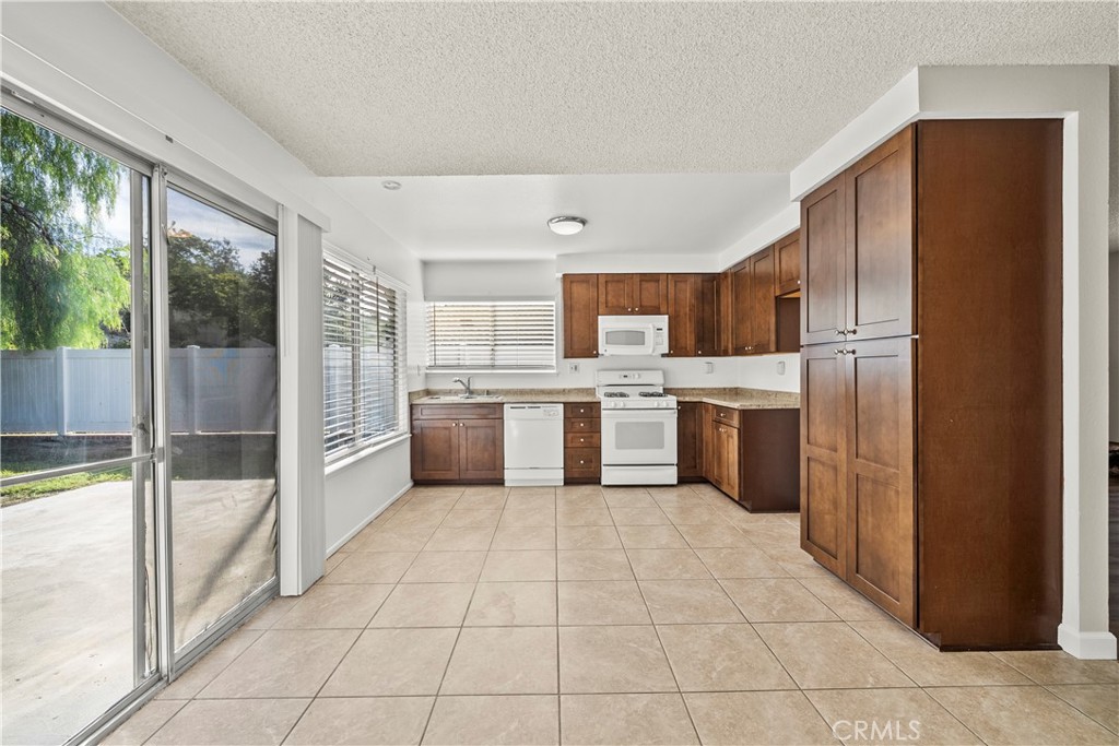 30008 Abelia Road Canyon Country, CA 91387 - Photo 7 of 32 a kitchen with stainless steel appliances granite countertop a refrigerator and a sink