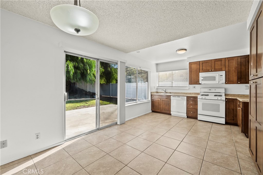 30008 Abelia Road Canyon Country, CA 91387 - Photo 8 of 32 a kitchen with a stove a sink and a refrigerator