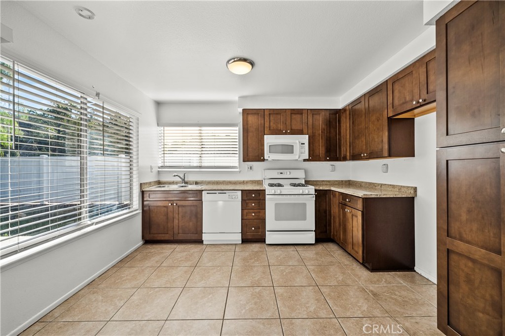 30008 Abelia Road Canyon Country, CA 91387 - Photo 9 of 32 a kitchen with a stove a sink and a refrigerator