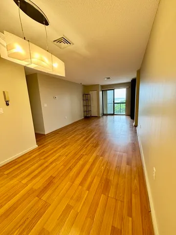 a view of a room with wooden floor