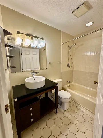 a bathroom with a double vanity sink toilet mirror and shower