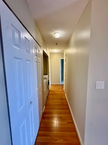 a view of a hallway with wooden floor