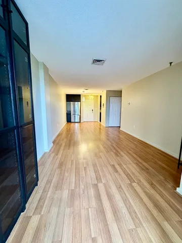 a view of a livingroom with wooden floor and staircase