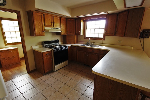 235 Grandin Road Morris, IL 60450 - Photo 5 of 20 a kitchen with stainless steel appliances granite countertop a stove a sink and a microwave