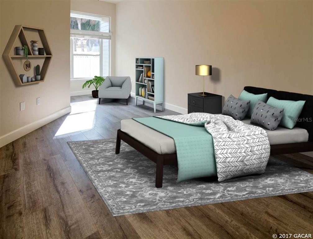10721 Northwest 65 Way Alachua, FL 32615 - Photo 1 of 1 a bedroom with a bed a couch and a window