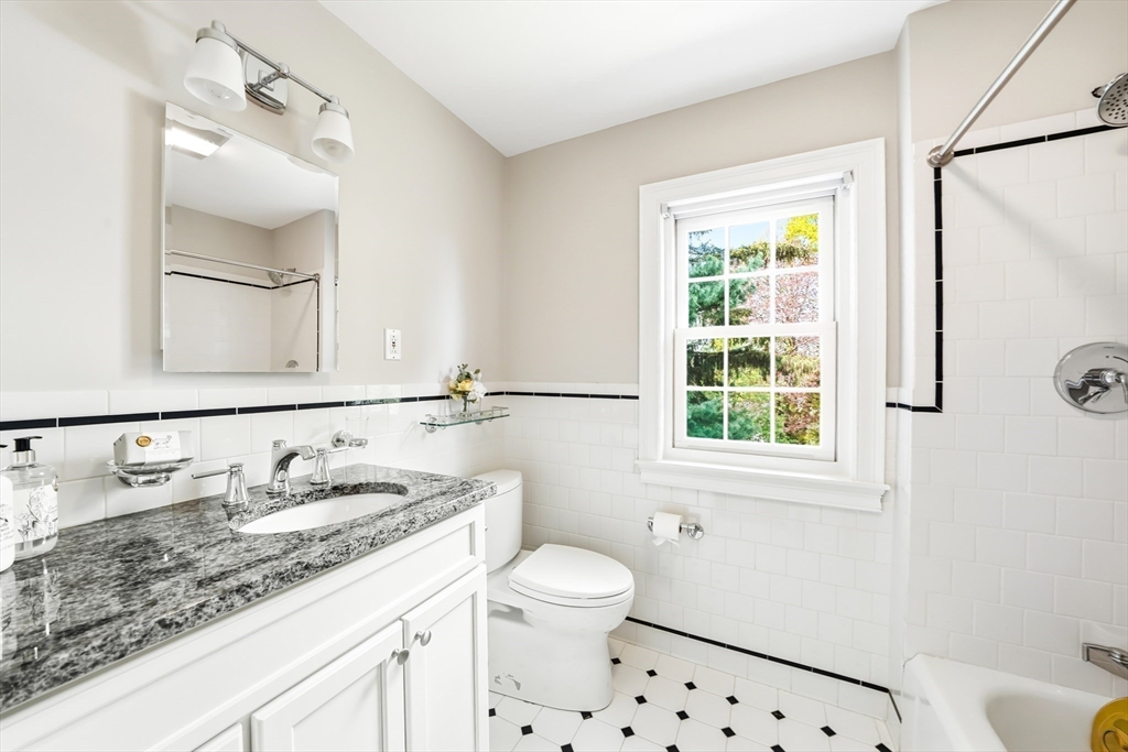28 Homer Road Belmont, MA 02478 - Photo 30 of 41 a bathroom with a granite countertop sink toilet a mirror and shower