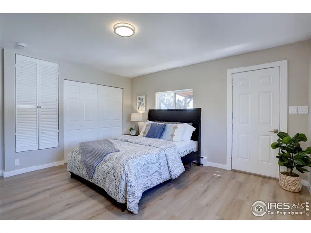 a bedroom with a bed and a potted plant