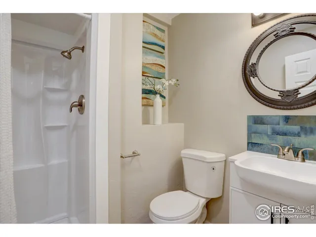 a bathroom with a toilet a sink and a mirror