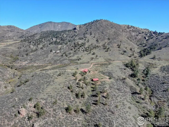 a view of a mountain with wooden fence