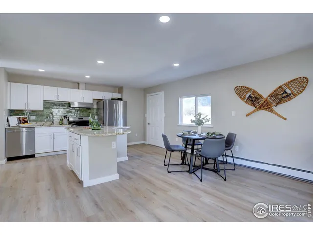 a kitchen with a table and chairs in it