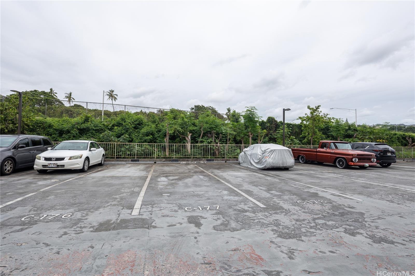 98-450 Koauka Loop, Unit 1108 Aiea, HI 96701 - Photo 18 of 22 a car parked on the side of the road