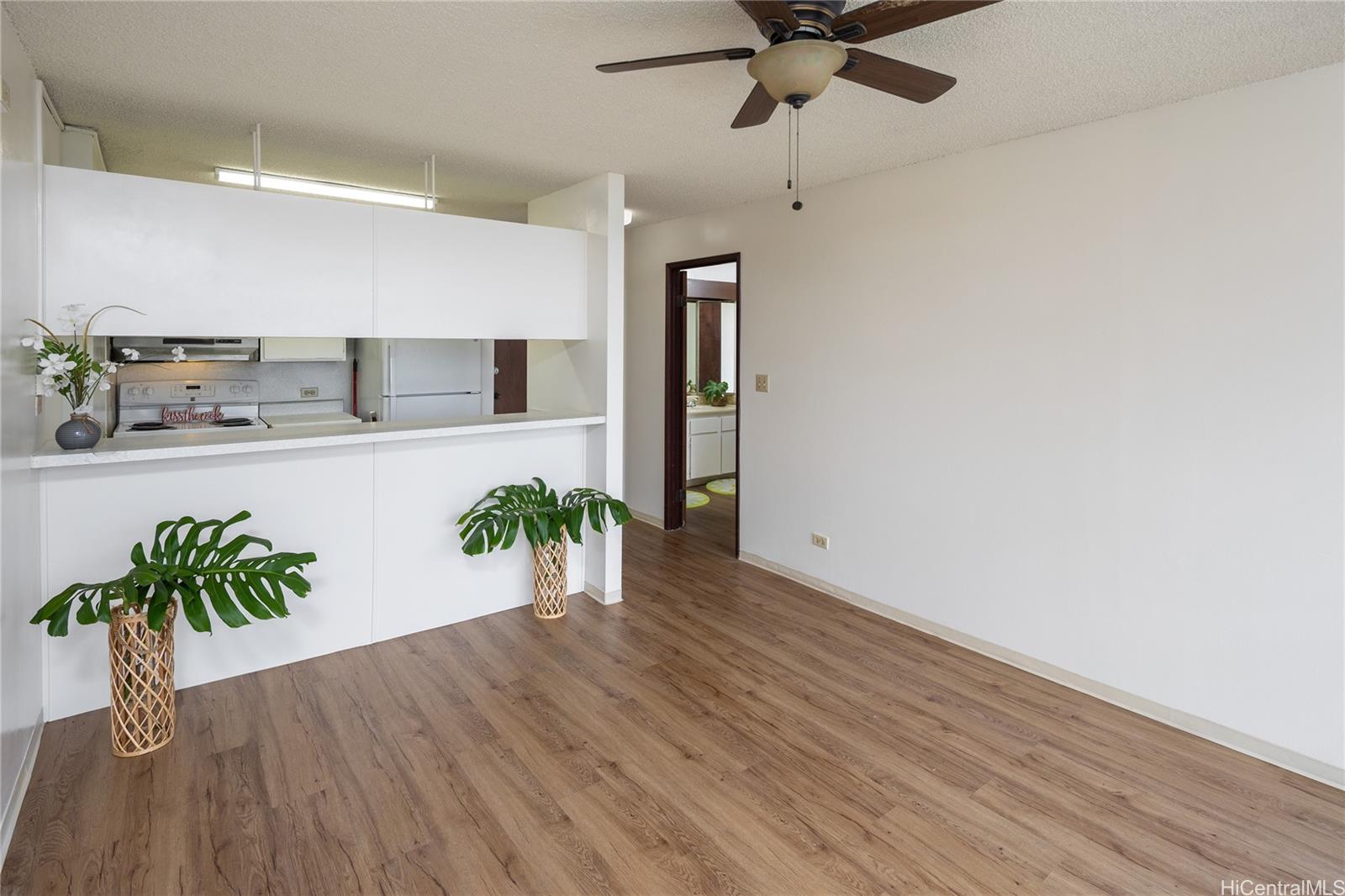 98-450 Koauka Loop, Unit 1108 Aiea, HI 96701 - Photo 4 of 22 a view of a workspace with wooden floor and a potted plant