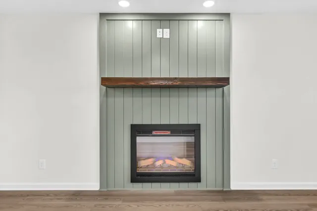 a kitchen with stainless steel appliances granite countertop a stove top oven a sink dishwasher and a refrigerator with wooden floor