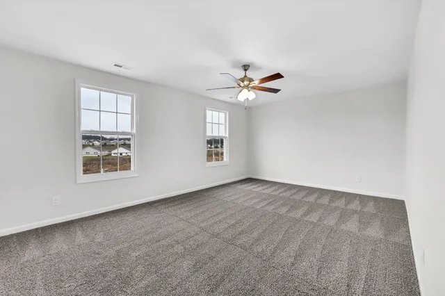 a view of an empty room with a fan