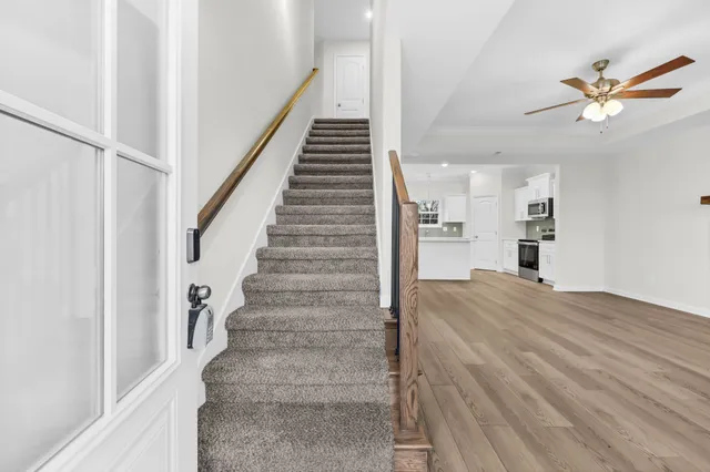 a view of entryway and hall with wooden floor