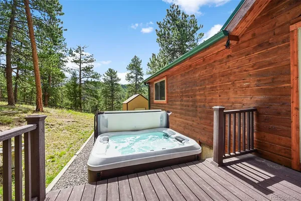 a view of a wooden deck with a yard