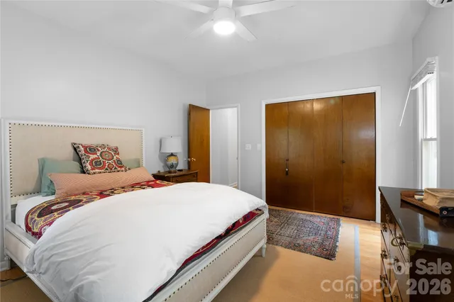 a bedroom with a bed and a table in it