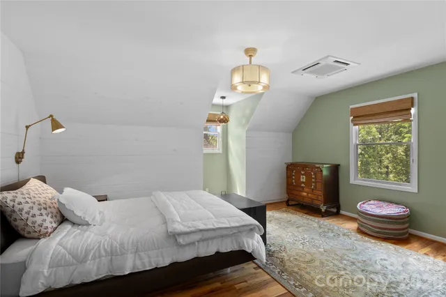 a bedroom with furniture and a window