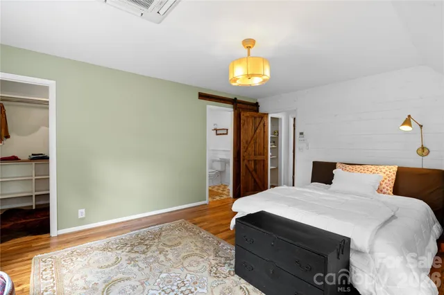 a bedroom with a bed and a stove with mirror