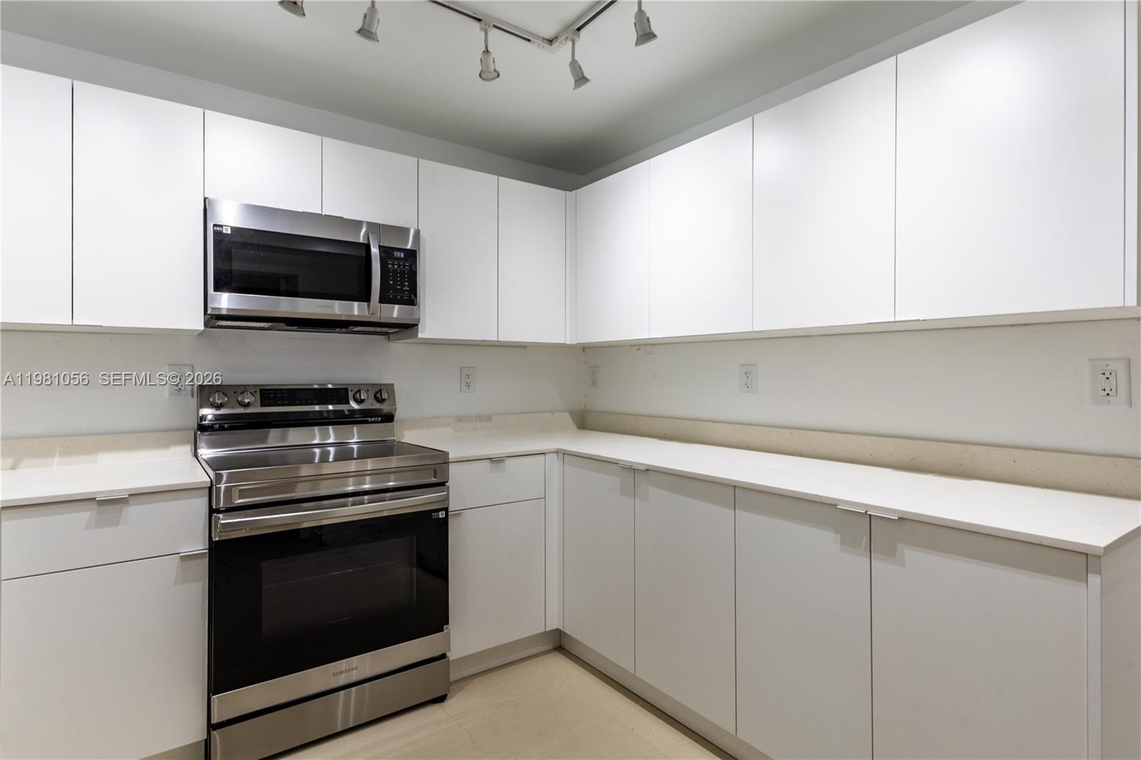 101 Ocean Ln Drive, Unit 1013 Key Biscayne, FL 33149 - Photo 12 of 28 a kitchen with stainless steel appliances granite countertop a sink dishwasher a stove and a microwave oven with cabinets