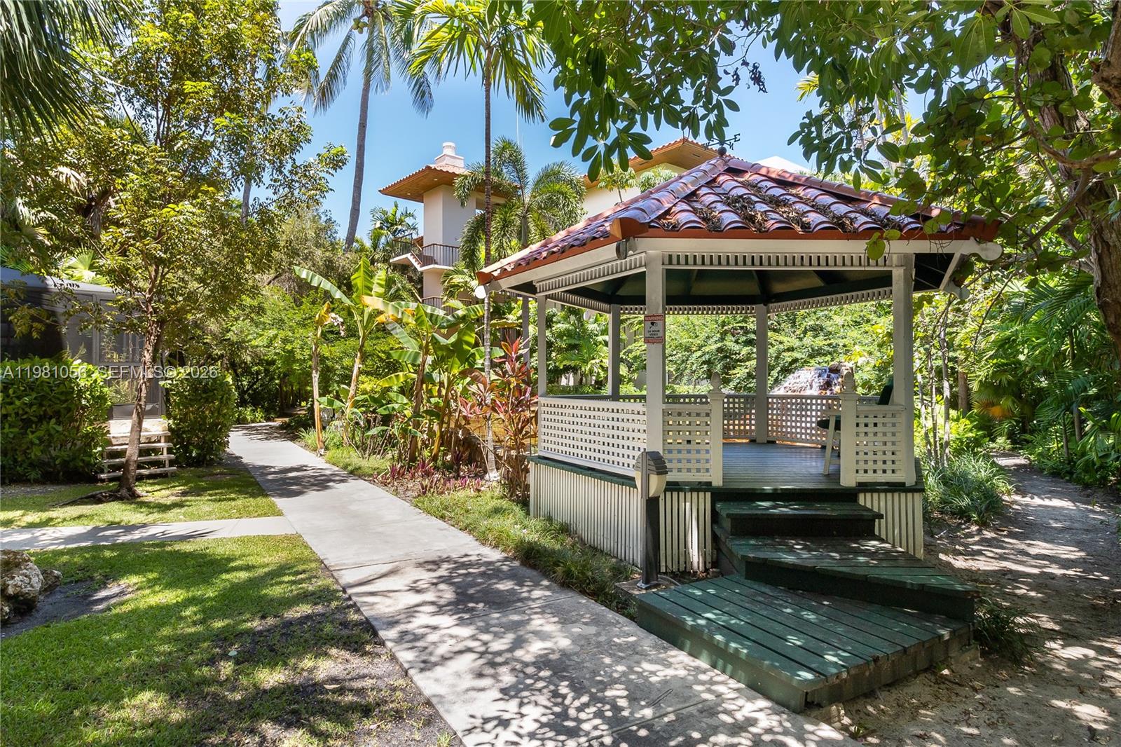 101 Ocean Ln Drive, Unit 1013 Key Biscayne, FL 33149 - Photo 23 of 28 a view of a patio with a table and chairs under an umbrella