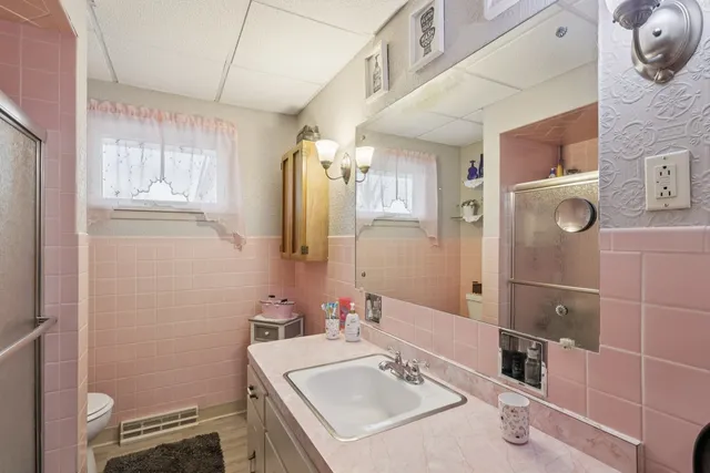 a bathroom with a sink toilet and shower