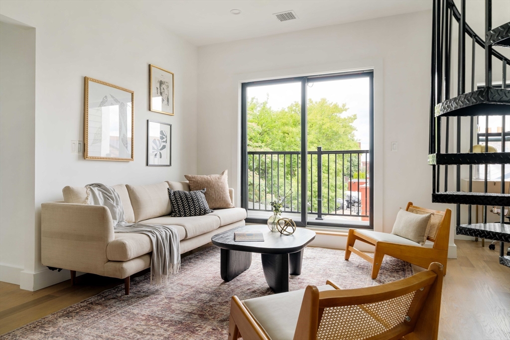 95 Addison Street, Unit PH7 Boston, MA 02128 - Photo 5 of 17 a living room with furniture and a large window