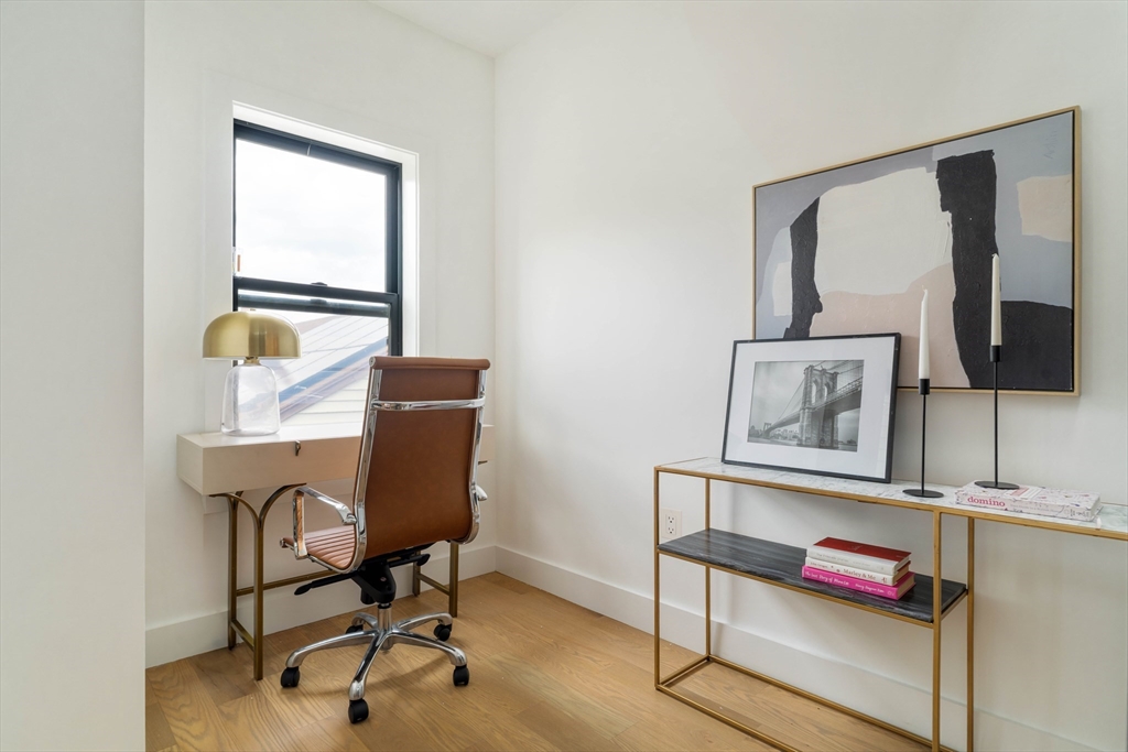 95 Addison Street, Unit PH7 Boston, MA 02128 - Photo 9 of 17 a view of a workspace with furniture and a window